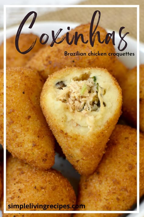 Coxinhas in a serving dish, with one opened, showing the chicken filling. Brazilian Pastries, Brazilian Coxinha Recipe, Brazilian Appetizers, Baked Chicken Croquettes, Brazilian Chicken Croquettes, Coxinha Recipe, Ramadan Snacks, Brazilian Food Traditional Aesthetic, Spanish Croquettes