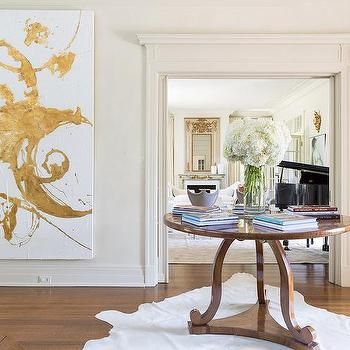 Round Foyer Table with Large Gold Abstract Art Rivers Spencer, Round Foyer Table, Round Entry Table, Entryway Table Modern, Foyer Furniture, Modern Foyer, White Cowhide Rug, Foyer Table, Modern Entryway