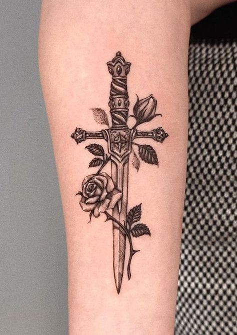 69 Striking Dagger Tattoos With Meaning Knife And Rose Tattoo, Rose And Dagger Tattoo, Cross Tattoo On Hand, Rose Tattoo With Name, Rose And Dagger, Rose Tattoo Meaning, Rose Hand Tattoo, Rose Tattoos For Men, Knife Tattoo