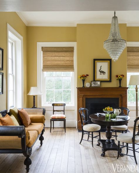 Antique cane sofa and chandelier; walls in Concord Ivory, Benjamin Moore Yellow Living Room Colors, Mustard Living Rooms, Yellow Walls Living Room, Yellow Decor Living Room, Mustard Yellow Walls, Brown Living Room Decor, Mustard Walls, Yellow Living Room, Living Room Color Schemes