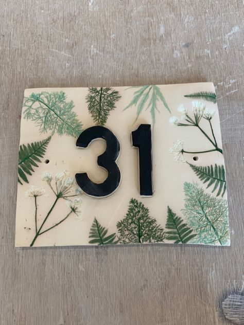 Handmade house number tile with rolled plants. Not yet had a final firing. Ceramic House Name Plaques, Ceramic Numbers House, Clay House Numbers, House Number Ceramic, Pottery House Numbers, Stairs And Hallway Ideas, Tile House Numbers, House Number Plates, House Name Signs