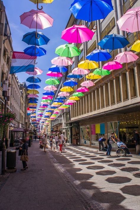 Shopping Street lined with colourful umbrella's in Luxembourg City  Do you think this is always here?? Luxembourg City, Colorful Umbrellas, Leg Pain, To Infinity And Beyond, Beautiful Country, City Travel, European Travel, Shopping Center, Oh The Places Youll Go