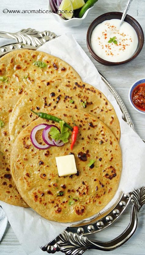 Aloo paratha is the most popular amongst all the paratha's! A paratha is an unleavened flatbread stuffed with a variety of filling from vegetarian to non-vegetarian. Some of the popular paratha's are gobhi paratha, aloo matar paratha, paneer paratha, methi paratha amongst the veg ones, and kheema paratha and egg parathas amongst the non-vegetarian counterparts. A typical Punjabi paratha is made with loads of ghee and served with a dollop of homemade butter. Definitely not the healthie... Alu Paratha, Chicken Peanut Butter, Methi Paratha, Aloo Paratha Recipe, Paneer Paratha, Indian Food Photography, Aloo Paratha, Paratha Recipe, Paratha Recipes