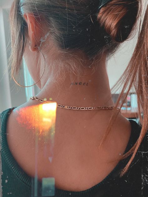 Womens Small Neck Tattoos, Angel Tattoo Behind Neck, Tiny Back Of Neck Tattoo, Back Of The Neck Tattoos Words, Angel Tattoo Neck Woman, Tiny Neck Tattoos For Women Words, Small Tattoo Back Of Neck, Pretty Back Of Neck Tattoos Women, Simple Back Of The Neck Tattoos