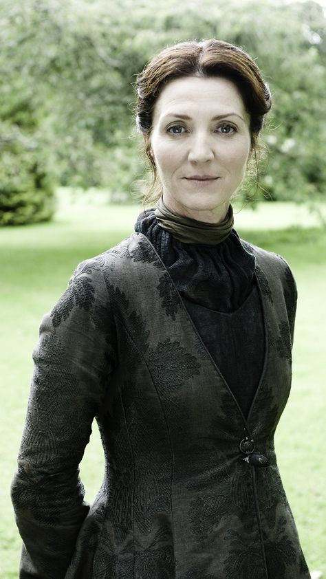 Catelyn Stark, née Tully, was born into House Tully as the daughter of Hoster Tully, the Lord Paramount of the Trident, and sister of Lysa and Edmure Tully. She married into House Starkthrough her marriage to Eddard Stark, though she was originally intended for Brandon Stark. Together, she and Eddard had five children: Robb, Sansa, Arya, Bran, and Rickon. Catelyn was a devoted mother and was fiercely protective of her children. Game Of Thrones Instagram, Medici Masters Of Florence, Michelle Fairley, Eddard Stark, Catelyn Stark, Got Costumes, Petyr Baelish, Game Of Thrones Costumes, Brooklyn 9 9