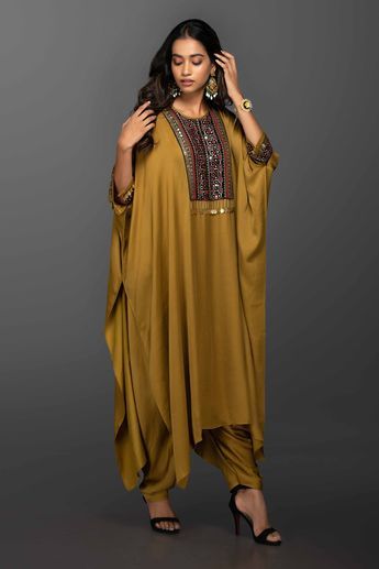 Gold mustard kaftan style kurta with Ajrakh embroidery and coin embellishments. Comes with dhoti pants. Components:2 Embroidered Neckline:Round Sleeve Length:Three Quarter Fabric:Satin Silk Color:Yellow Asymmetrical kurta hemline Side slits Sleeves with embroidered hems and button closure - Aza Fashions Kaftan Kurta, Kaftan Designs, 2piece Outfits, Dhoti Pants, Kaftan Style, Mode Abaya, Yellow Satin, Silk Kaftan, African Clothing Styles