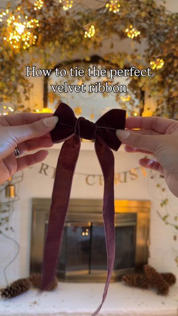 Wendy on Instagram: "Here’s how to tie the perfect double looped velvet ribbon. Consider adding bows to your decor this year. I love how this simple DIY can freshen up your holiday decor without breaking the bank. You can choose any colour of ribbon you like and you can make them as small or as big as you want!   Comment SHOP for the links to pretty ribbons that would look great for this DIY.   Hi I’m Wendy. I like Christmas and DIYs. Like really really like Christmas. Welcome to my series, the 24 days of Christmas diys, recipes and activities.   Welcome to day one.   Here’s how you tie the perfect ribbon.   Take 3 feet of ribbon and hold it in the palm of your left hand. Flip your hand over and bring the ribbon over your thumb. Now make a figure 8 and weave under your pointer finger. Turn Christmas Wreaths With Velvet Ribbon, Velvet Ribbon Christmas Garland, Tying Velvet Ribbon, Diy Velvet Ribbon Bow, Ribbon On Mantle, How To Make A Velvet Ribbon Bow, Velvet Ribbon Bow Tutorial, Velvet Ribbon On Wreath, Tying A Bow With Velvet Ribbon