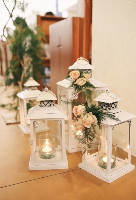 White Lanterns Wedding Aisle, How To Decorate Lanterns For Weddings, Decorated Lanterns Ideas Wedding, Wedding Lanterns With Flowers, Modern Lantern Centerpieces, Small Lantern Centerpieces, Wedding Aisle Indoor, Wedding Aisle Lanterns, Aisle Decorations Wedding Indoor