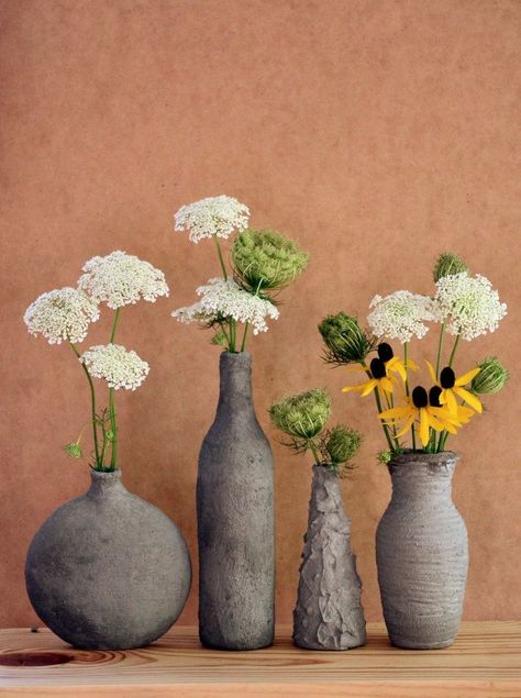 These cement-covered glass vases are both easy and fun to make! [media_id:3477958] First, get yourself an inexpensive glass vase, or get a glass bottle from you… Cement Furniture, Cement Vase, Old Glass Bottles, Easy Diy Decor, Concrete Furniture, Concrete Crafts, Cement Crafts, Concrete Projects, Diy Simple