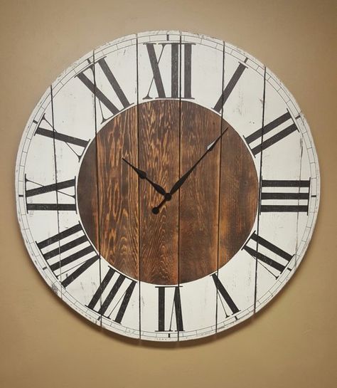 This farmhouse wall clock features a white and stained distressed finish with hand painted roman numerals and antique style spade hands. It requires one AA battery (not included) and comes with hardware to hang it. This clock is available in 4 sizes; 18 inch, 24 inch, 29 inch, and 36 Farmhouse Clock, Wall Clock Decor, Big Clocks, Farmhouse Clocks, Big Clock, Farmhouse Wall Clocks, Farmhouse Wall Clock, Rustic Inspiration, Rustic Clock