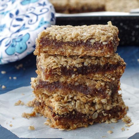 This date slice is a classic Canadian dessert. Also known by the names date square, matrimonial bars, squares or slice, matrimonial cake, date crumble, and date bar. This is my Grandma's recipe and by far, the best date square I have ever tasted! This simple recipe is especially popular during the holidays, although it's great for any time of the year. It's often served at Christmas markets, bake sales, church gatherings, and funerals. It pairs perfectly with a cup of coffee or tea. Matrimonial Cake, Date Slice, Date Square, Canadian Dessert, Oatmeal Crumble, Date Squares, Slice Recipe, Vegan Bar, Oat Crumble