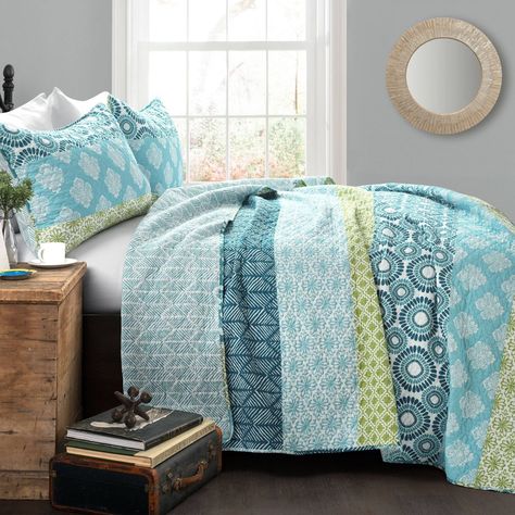 With the feeling of a rainbow, this Bohemian Stripe Quilt 3 Piece Set brightens your bedroom with aesthetic patterns and countless colors in each of her many arcs. From serene floral designs to twirling patterns, this pattern truly has a story to tell. From top to bottom, the colorful patterns brighten the room and add boho style to your space. The reverse side features a blue geometric print if you ever need a more toned-down look. The Bohemian Stripe Quilt 3 Piece Set includes a soft cotton qu Blue Bedding Sets, Cotton Quilt Set, Boho Quilt, Striped Quilt, Lush Decor, Quilted Sham, Blue Quilts, King Quilt, Reversible Quilt