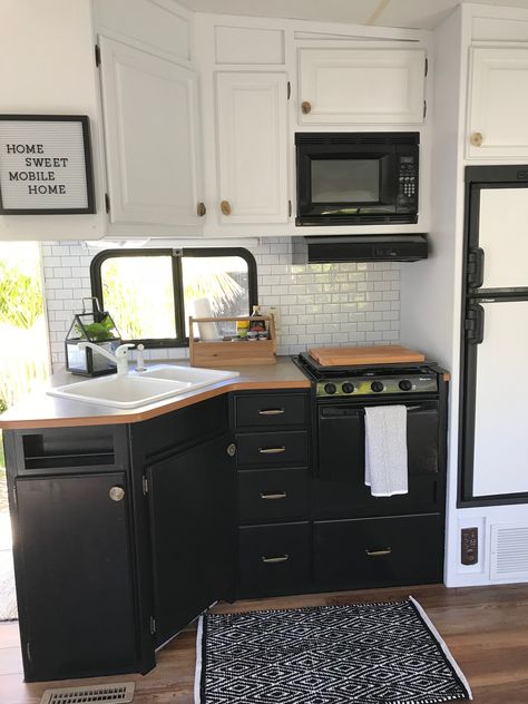 Rv reno and remodel-Giani cabinet paint is no joke! I dropped an ENTIRE can of white paint on the black lower cabinets painted with Giani and they cleaned up perfect! Black Lower Cabinets, Rv Kitchen Remodel, Rv Interior Remodel, Caravan Makeover, Camper Trailer Remodel, Vintage Camper Remodel, Diy Camper Remodel, Rv Makeover, Rv Kitchen