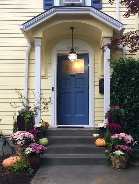 Blue Shutters Yellow House, Yellow House Navy Door, Yellow House With Blue Door, Yellow And Blue House Exterior, Yellow House Color Scheme Exterior, Front Door Yellow House, Light Yellow House Exterior, Yellow House With Blue Shutters, Yellow House Blue Door