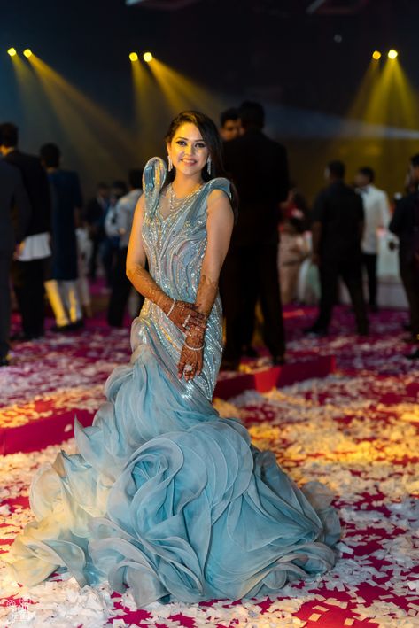 Lovely grey and ice blue ruffled gown for a sangeet and cocktail night | WedMeGood| Vivek & Dimple| #wedmegood #indianweddings #gown #indowestern #ruffled #sangeet #cocktail Cocktail Gowns Indian Weddings, Fishcut Gown Western, Fishcut Dresses, Reception Gown For Bride, Gaurav Gupta Gowns, Bride Reception Dresses, Sabyasachi Bridal, Lovely Grey, Indian Wedding Gowns