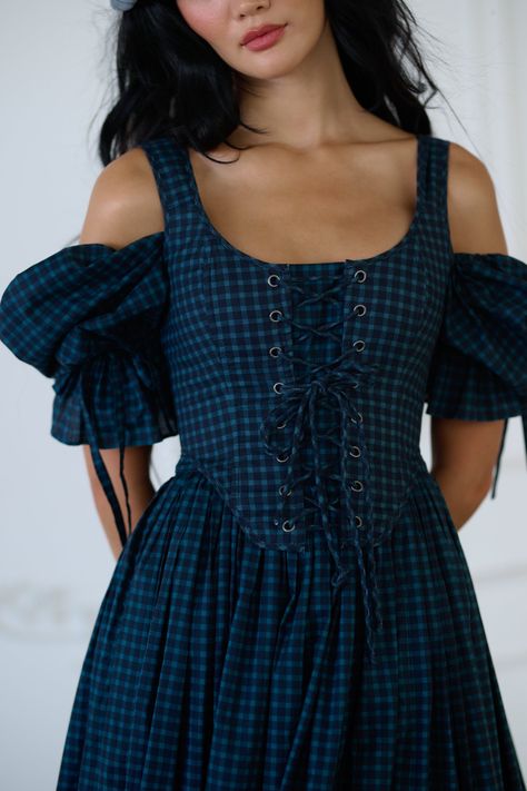 Inspired by fall moments in the French countryside, the Duchess Corset now features a rich blue tartan in 100% heavy cotton. This fully boned corset laces up with two drawcords, allowing you to control the cinch precisely. Perfect for crisp September mornings at the local boulangerie or cozy evenings by the hearth as autumn settles in. Style with the Farmhouse Tartan Market Dress to complete the look. Heavy cotton lace-up bodice corset Includes two draw chords Boning for structure Double lined w The Cinch, Skirt Swimsuit, Market Dress, Puff Dress, Blue Tartan, The Farmhouse, French Countryside, Lace Corset, Knitted Coat