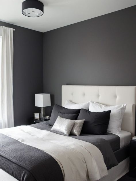 Create a chic and modern bedroom by incorporating a charcoal grey accent wall. Pair it with a sleek platform bed, crisp white bedding, and metallic accents for a sophisticated look. Charcoal Grey Accent Wall, Charcoal Bedroom Walls, Charcoal Grey Walls, Charcoal Grey Bedrooms, Accent Wall Inspiration, Grey Accent Wall, Grey Bedroom Decor, Wall Inspiration, Dark Bedroom