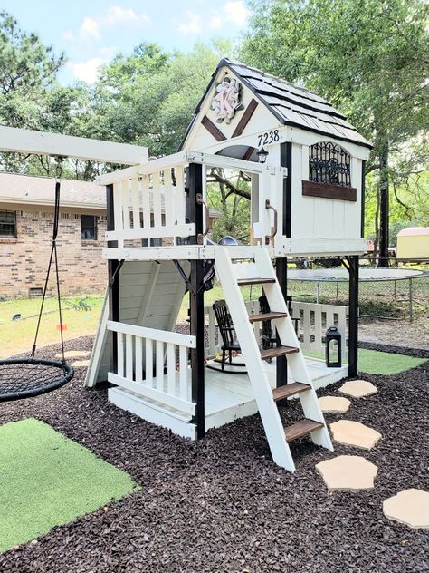 Modern Farmhouse Playhouse finally done!!! I've been working on this for a month and I am happy how it turned out. This playset was given to Nygel when he was about 3, I wanted to give it an upgrade for Kennedy. I had some men put new decking wood on it bc some of the previous wood rotted . I painted, layed down rubber mulch, a flower bed, added a platform swing, reading nook, rocking chairs and other decor. Kennedy is ready to play! This was fun and I cant wait to decorate it for holidays!!! #q Upgrade Outdoor Playset, Modern Farmhouse Playhouse, Playground Upgrade Ideas, Painted Playset Outdoor, Modern Playset, Farmhouse Playground, Farmhouse Playset, Painted Playset, Playground Upgrade