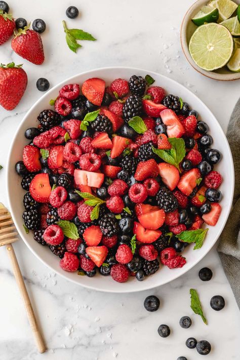 This easy Summer Berry Salad features fresh mixed berries, mint, and a delicious honey lime dressing. It's light and healthy, and also great to serve for a crowd. And even better: this fruit salad only takes 5 minutes! Gluten free, dairy free, paleo, vegetarian. Mixed Berry Recipes Healthy, Gluten Free Dairy Free Fruit Salad, Mixed Berry Fruit Salad, Mixed Berry Parfait, Easy Kabobs, Nana’s Berry Bliss Frozen Fruit Salad, California Chicken, Honey Lime Dressing, Berry Salad