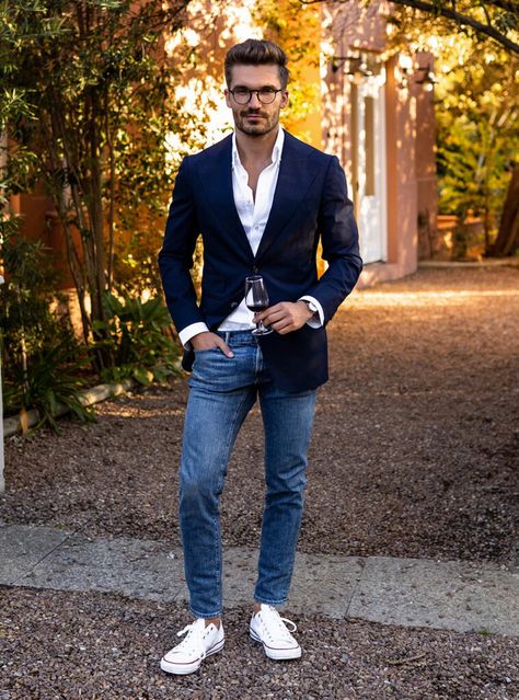 A seamless blend of formal and casual with a sharp navy blazer and white shirt paired with blue jeans and crisp white sneakers, perfect for any occasion that calls for stylish versatility. Jean And Sport Coat Men, Navy Blue Blazer Outfit Mens Casual, Navy Blue Blazer Outfit Mens, Blazer And White Shirt, Blazer White Dress, Navy Blue Blazer Outfit, Navy Blazer Outfits, White Tennis Shoes Outfit, Jeans White Sneakers