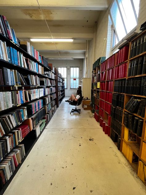 A woman sitting in a rolling chair in the middle of two isles containing 7 layers of books Cincinnati Ohio Aesthetic, Ohio Gothic, Ohio Aesthetic, Midwest Gothic, Library Aesthetic, Gothic Aesthetic, Cincinnati Ohio, Landscape Scenery, Cleveland Ohio