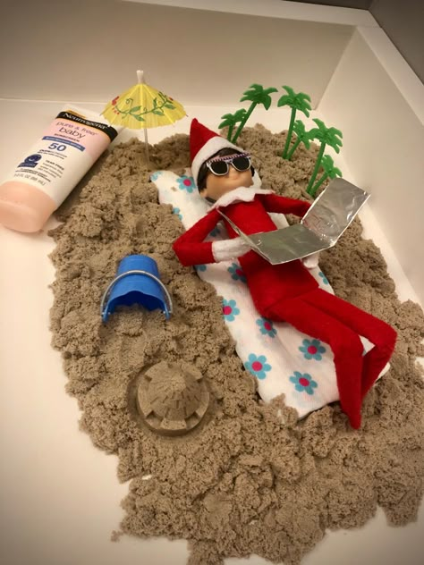 2020 Day 15: Cocoa the Scout Elf made a beach out of kinetic sand so he could relax and work on his tan Elf On The Shelf Relaxing, Elf On Shelf Beach Ideas, Elf At The Beach, Elf Beach Ideas, Beach Elf On The Shelf, Elf Working Out, Vacation Elf On The Shelf Ideas, Scout Elf Ideas, Elf On The Shelf Beach Ideas