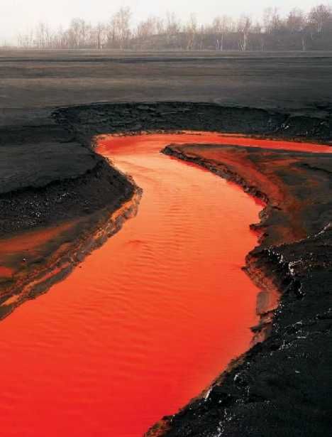 the brilliant vermilion river above, tainted by toxic tailings from a nearby nickel mine in Canada. The photograph, taken by Edward Burtynsky in 1996, depicts an eerie and forbidding landscape. Fashion Pollution, Sudbury Ontario, Photos Of Art, Red River, Our Environment, Shades Of Red, Planet Earth, Volcano, Mother Earth