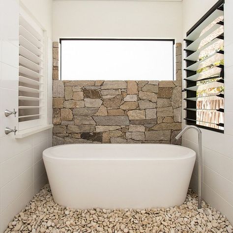 Half wall in natural stone and pebbles on the floor turn the the small bathroom into a relaxing hub [Design: Sam Davison Interiors] Bathroom Stone Wall, Stone Tile Bathroom, Bathroom Renovation Cost, Natural Stone Bathroom, Minimalist Bathroom Design, Bathroom Remodel Cost, Stone Bathroom, Bathroom Remodel Tile, Bathroom Decor Apartment