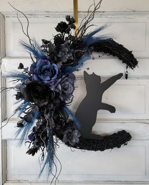 "Blue Halloween Cat Moon Wreath Witchy Crescent w/ Onyx Crystal * Gothic Celestial Door Hanger * Spooky Lunar Decor * Kitty Lovers Gift Spooky, celestial and beautiful.🖤 This witchy kitty sitting on the moon wreath not only has lots of character and dimension but also features a dangling authentic obsidian crystal. The black grapevine wreath is 18\" and the witchy black kitty is 12\" tall. This cat wreath makes a fabulous gift for any cat lover. I only create my wreaths with the highest quality flowers and greenery. All artificial for use year after year. (^..^) Please be aware the crystal may vary. All wreaths are made to order and are not exact BUT are made with the same attention to detail. ฅ^*ﻌ*^ฅ" Moon Wreath Crescent, Blue Halloween Decor, Witchy Wreaths, Moon Wreath, Floral Door Wreaths, Boho Wreath, Chat Halloween, Witchy Crafts, Diy Crafts Hacks