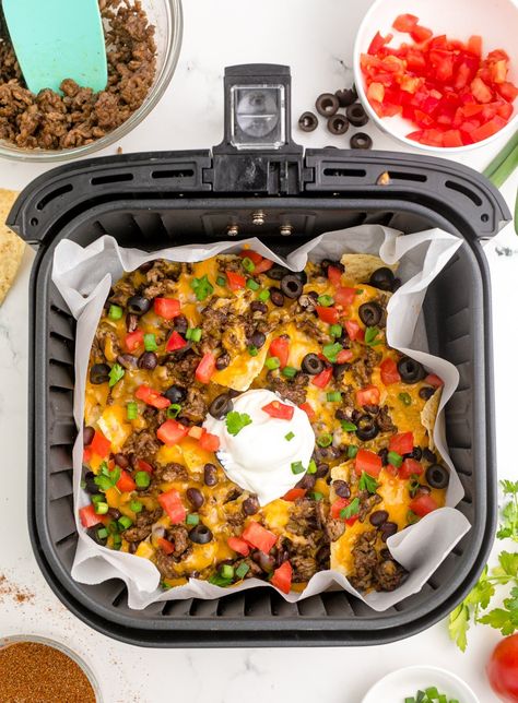 Air Fryer Nachos are here for the win! You can enjoy this as an easy snack by piling on your favorite toppings in less than 15 minutes!