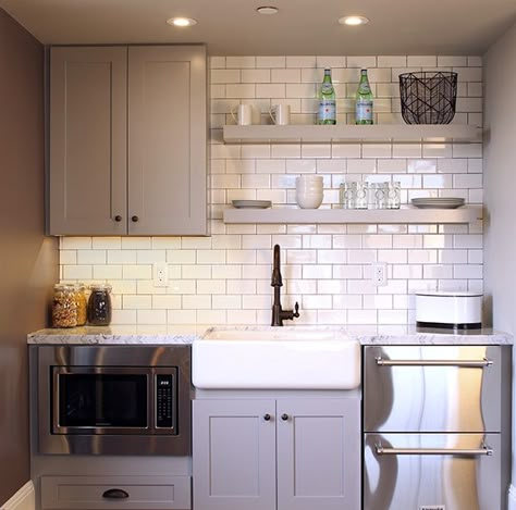 Kitchenettes are idea of in-laws suites. This one from the BUILDER Responsive Home Contemporary Farmhouse features Rittenhouse Square in Arctic White 3 x 6 on the wall and Daltile Marble in Carrara Gioia (Polished) on the countertop. Casita Kitchen, Basement Addition, Office Kitchenette, Small Basement Kitchen, Garage Transformation, Basement Kitchenette, Small Kitchenette, Basement Kitchen, Basement Apartment