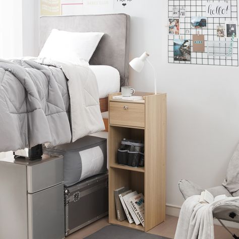 Perfect for saving space in dorm rooms or small bedrooms, this tall bookcase nightstand is also ideal for higher beds. Place your alarm clock, lamp, and more on the top without worrying about them falling off thanks to a small ledge. Dorm Room Side Table, Tall Bedside Table Ideas, Boy Dorm Rooms, Bedside Storage Ideas, Tall Nightstand, Dorm Nightstand, Single Dorm Room, Tall Bedside Table, Boys Dorm Room