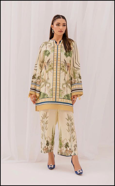 MARFA (PRE-ORDER) This 2 PCs stitched Co-Ord set includes: Shirt Trouser Fabric: Lawn Silk This stunning green and beige matching separates unravel floral and leafy prints spread all over the silk silhouette. Sleeves are adorned with beautiful hanging tassels that gives it a unique and chic look. It is paired with matching statement culottes perfect for a modern affair.Dispatch time : 3-5 weeks Pakistani Kurta Designs, Hanging Tassels, Pakistani Kurta, Co Ords Outfits, Organza Suits, Matching Separates, Fabric Print Design, Shirt Trouser, Printed Silk Shirt