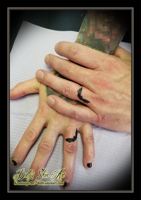 small black bat bats matching ring finger solid hand tattoo his her tattoo kamloops tattoo dolly's skin art Halloween Wedding Ring Tattoo, Bat Tattoo On Finger, Finger Bat Tattoo, Dragon Ring Tattoo, Bat Finger Tattoo, Matching Bat Tattoos, Bat Hand Tattoo, Halloween Finger Tattoos, Bat Tats