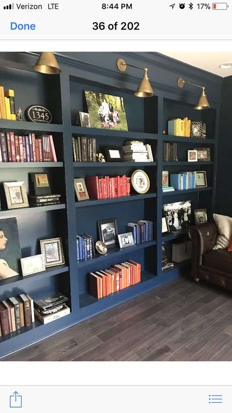 Black built in shelves with lighting for next to half wall Built In Shelves With Lights, Navy Bookshelves Built Ins, Library Shelf Lights, Navy Shelves, Slim Built In Bookcase, Bold Built Ins, Basement Built In Bookshelves, Bookcase Wall With Lights, Wall Of Built In Shelves