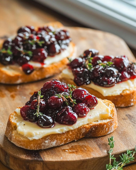 Elevate your appetizer game with these Crispy Crostini featuring creamy baked brie, topped with balsamic roasted cranberries. A perfect blend of sweet, savory, and tangy flavors that’s easy to prepare and sure to impress! Crostini With Brie And Cranberry, Roasted Balsamic Cranberry And Brie Crostini, Baked Crostini Appetizers, Cranberry And Brie Crostini, Strawberry Balsamic Crostini, Valentines Baked Brie, Cranberry Hors D’oeuvres, Cold Crostini Appetizers, Crustini Appetizers Brie