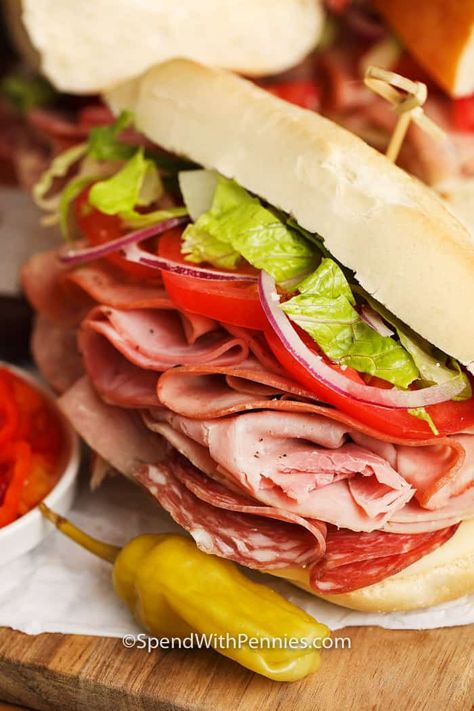 The best Italian sandwich is topped with 4 hearty meats, cheese, and a zesty Italian dressing. This easy sandwich recipe is great for a crowd. #spendwithpennies #Italiansub #sandwich #foracrowd #lunch #bestsandwichrecipe Chopped Sliders, Sub Sandwich Ideas, Cauliflower Sandwich, Italian Sub Sandwich, Sandwich Italian, Italian Sandwich Recipes, Subway Sandwiches, Cold Cut Sandwich, Subs Sandwiches