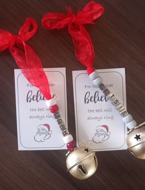 "Personalised Believe 2023 jingle bells.A large bell with star detail.Personalised with name in silver letter beads and coloured beads of your choice,with a 2023 and Believe charm.Comes on red ribbon,attached to card with quote \"for those that Believe the bell will always ring\"Perfect for Christmas eve boxes or as a stocking filler.Choose name and bead colour of your choice.Handmade. If there is a particular colour ribbon 🎀 or bead choice you require,please pop me a message ." Santa Bell, Crafts With Bells Christmas, Bells Craft, Kids Homemade Christmas Ornaments, Bead Christmas Ornaments, Letter Beads Ideas, Christmas Bells Decorations, Christmas Bells Craft, Preschool Christmas Ornaments