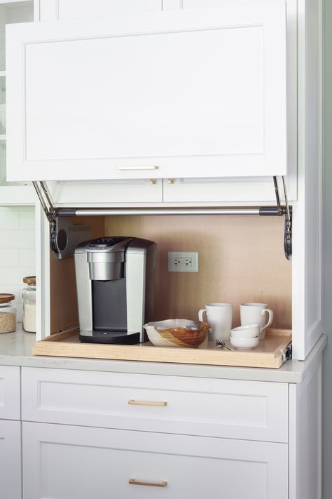 This coffee area with pull-out shelf is perfect kitchen storage idea. Incorporating an appliance garage for your kitchen appliances is a great way to keep them accessible but still out of site. 
#kitchenappliancegarage #kitchenstorageideas #coffeebar #kitchendesign #kitchenstoragecabinet #pulloutshelf Hide Appliances, Coffee Station Kitchen, Kitchen Appliance Storage, Appliance Garage, Hidden Kitchen, Coffee Bars In Kitchen, Appliances Storage, Home Coffee Bar, Studio Kitchen