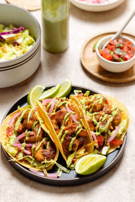 These Spicy Shrimp Tacos are packed with flavor and perfect for the summer. They're made with a slaw tossed in Green Goddess dressing, quick pickled red onions, pico de gallo, and spicy sauteed shrimp. Everything except the shrimp can be made ahead so they're super easy to put together! Creamy Cilantro Sauce, Shrimp Tacos Recipe, Homemade Taco Seasoning Mix, Quick Pickled Red Onions, Spicy Shrimp Tacos, Avocado Salad Dressing, Flavorful Shrimp, Quick Pickled Onions, Goddess Dressing