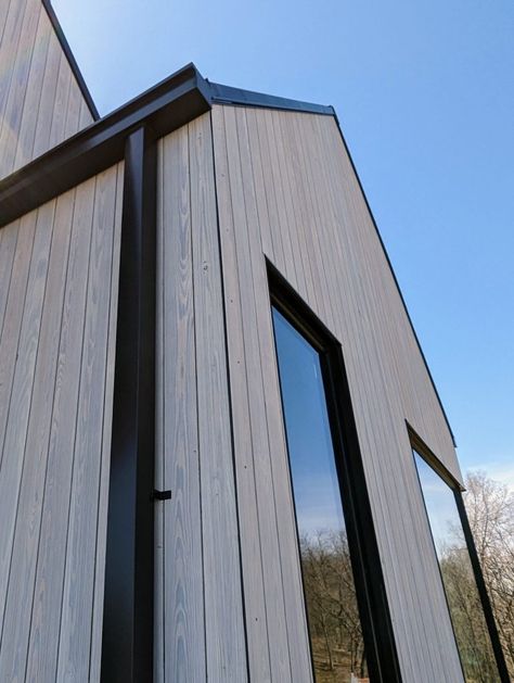 Thermally Modified Wood Siding, Modern Window Trim Exterior, Modern Wood Siding Exterior, Black Gutters, Vertical Siding Exterior, Modern Window Trim, Vertical Wood Siding, Scandinavian Cabin, Wood Siding Exterior