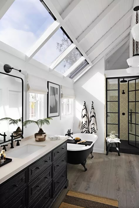 This bathroom is bathed in natural light. Lined with hand-painted, cream-and-black tile from Mission Tile West, the shower features a steel-and-glass door that looks vintage. #greenhomedecor  #bathroomideas #bohobathroom  #bhg Black Leathered Granite Countertops, Mission Tile West, Dnevni Boravak, Mission Tile, Full Bathroom Remodel, Black Tile, Bathroom Color Schemes, Decorating Advice, Garden Spring