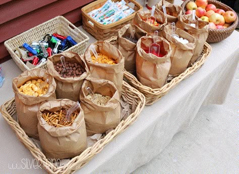 Put all of the snacks in paper bags for easy cleanup, such a cute trail mix bar idea. Make Your Own Trail Mix Bar, Trail Mix Bar Make Your Own, Trail Mix Bar Ideas, Wedding Trail Mix Bar, Snack Mix Bar, Camping Party Theme, Trail Mix Bars, Snack Bar Ideas, Trail Mix Bar