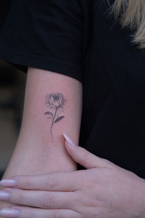 Artist Daria Iatskevich @birdy.ink on instagram #shouldertattoo #armtattoo #delicatetattoo #floraltattoo #botanicaltattoo #linework #blackink #tattoographic #peonyart #flowertattoo #singleneedle #tattoosketch #tattooideas #finelinetattoo #flowerart #naturetattoo #minimalismtattoo botanicaldrawing #peony Peony On Stem Tattoo, Peony Tattoo Shading, Small Peony Flower Tattoo, Bouquet Of Peonies Tattoo, Minimalistic Peony Tattoo, Small Peony Tattoo Black, Simple Peony Flower Tattoo, Peonies Fine Line Tattoo, Dainty Peony Flower Tattoo