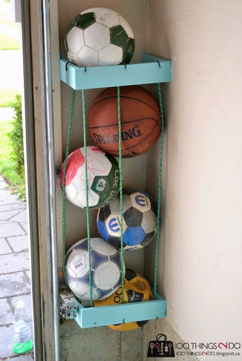 Tuck them around two 2x4 boxes to organize all of the sports balls taking up space in your garage. | 35 Brilliant Ways Bungee Cords Can Solve All Your Problems Garage Hacks, Outdoor Toy Storage, Sports Equipment Storage, Storage Hacks Diy, Diy Toy Storage, Garage Storage Solutions, Ball Holder, Tool Storage Diy, Ball Storage