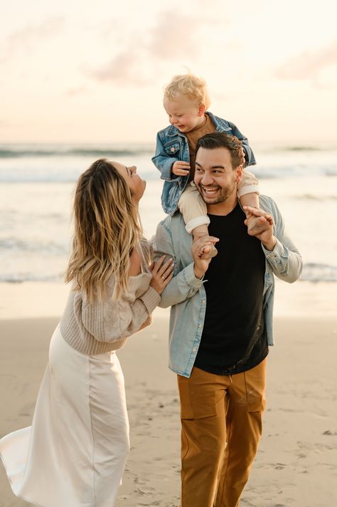 San Diego family photos of young family walking along beach at sunset with dad holding toddler boy on his shoulders at Fletcher Cove Solana Beach California Summer Family Photos Beach, Modern Family Beach Pictures, Family On The Beach Photography, Fall Family Pictures Outfits Beach, Golden Hour Beach Family Photoshoot, Family Beach Session Outfits, Family Beach Pics Ideas, Family Beach Pictures Winter, Family Of 3 Beach Photoshoot