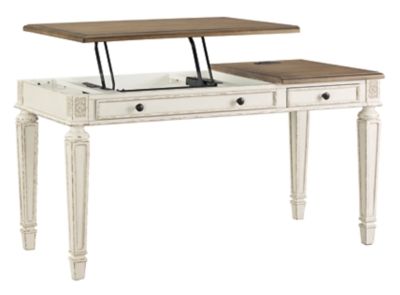 Elevating the art of traditional cottage styling, the Realyn desk is your heavenly home office realized. Antiqued two-tone aesthetic blends a chipped white with a distressed wood tone top for added charm. Framed drawer fronts, decorative corbels and elegantly turned and tapered legs add refinement, while dark bronze-tone knobs lend a classic touch. Spring lift top raises the surface to a comfortable standing position, for a healthy alternative. Built for looks and productivity, the built-in ... Lift Top Desk, Brown Home Office, Decorative Corbels, Traditional Cottage, Upholstered Stool, Ashley Furniture Homestore, Office Set, L Shaped Desk, Upholstered Fabric