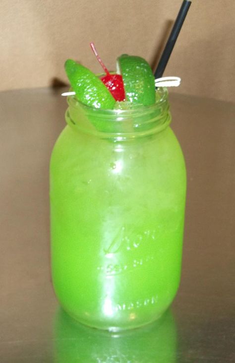 Toby Keith’s Swamp Water  (prepare in mason jar over ice)  1.25 ounces – Wild Shot Silver Tequila  2.25 ounces – Apple Pucker  .75 ounces – Simple Syrup  Splash of Midori  Fill with Sweet & Sour Mix. Float lime juice, garnish with 2 limes and a cherry. Add 2 drops of green food coloring to darken the green (optional) Apple Pucker, Swamp Monster, Swamp Water, Swamp Cooler, Short Glass, Sour Mix, Toby Keith, Solo Cup, Green Food