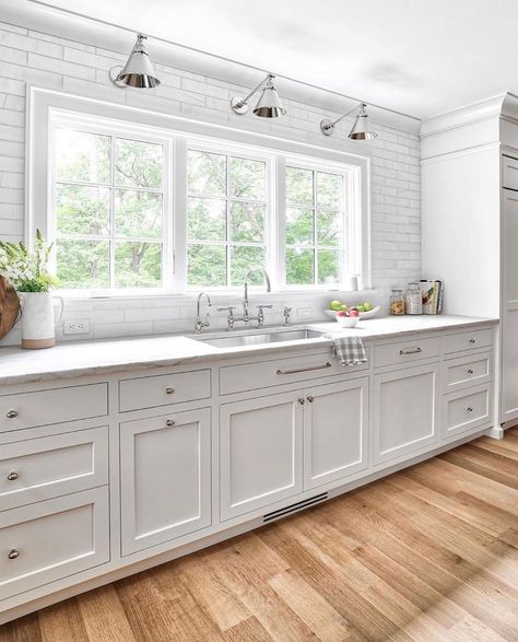 30 Gorgeous White Kitchen Cabinet Hardware Ideas Kitchen With Big Window Over Sink, Wall Of Windows Kitchen, Kitchen Windows Above Sink Ideas, Kitchen With Large Windows, Kitchen Cabinet Door Styles, Kitchen Window Design, Kitchen Windows, Kitchen Cabinet Styles, Cabinetry Design