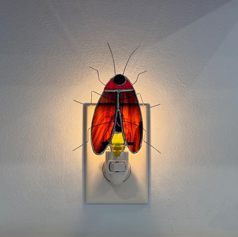 Oh, the Fireflies of summer...to catch them in a jar and watch them light up for hours!  Now, you can plug in this stained glass night light and enjoy the soft glow all night long.  This Firefly, or Lightning Bug, has streaky brown wings and an amber tail that lights when the on/off switch is turned on.  Comes complete with 4watt bulb. Plug In Night Light, Stained Glass Night Lights Diy, Stained Glass Light Bulb, Lighting Bugs Fireflies, Stained Glass Night Lights, Tiffany Stained Glass Smashing Stained Glass & Lighting, Happy House, Cottage In The Woods, Dream Apartment